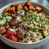 This nourishing Customizable Grain Bowl showcases tofu, quinoa, avocado, and crunchy pumpkin seeds for a colorful meal prep lunch.