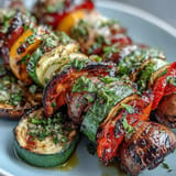 Smoky, colorful grilled veggie kabobs generously drizzled with fresh chimichurri sauce.