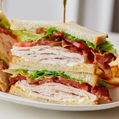 Crispy bacon and juicy tomato star in this classic, layered Turkey Club Sandwich.