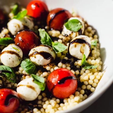 Caprese Couscous Salad features tender pearled couscous, creamy mozzarella, juicy tomatoes, and fresh basil.