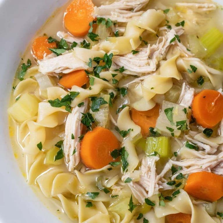 Golden egg noodles and shredded chicken swim in flavorful broth of Chicken Noodle Soup.